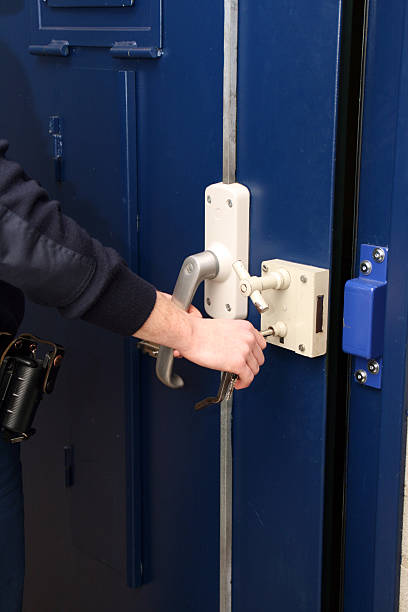 Blue Door with a man's hand opening conveniently the newly rekeyed door by 512 Locksmith, Commercial Rekey Services in Fort Hood Texas