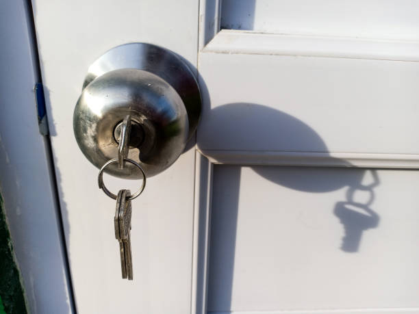 White door with silver door knob. This door lock has been rekeyed by rekey service Buda TX