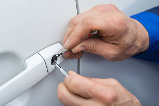 Close-Up Of Person Hand Holding Lockpicker To Open Car Door Automotive Locksmith Austin TX