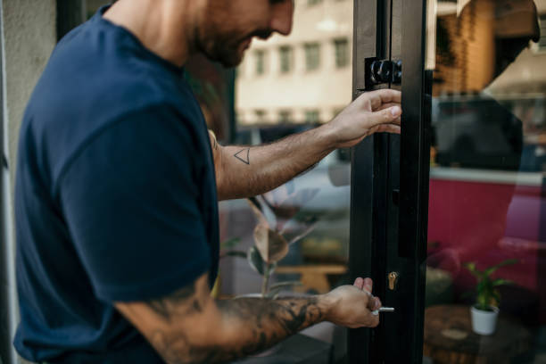An Unrecognizable Man Unlocking And Opening Door Of His Store In The Morning Commercial Door Lockout? 512 Locksmith in Hutto TX got you