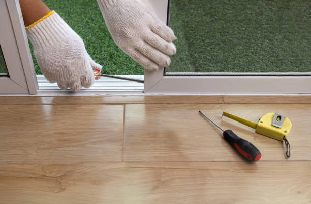 Worker Adjust Roller Of Aluminium Sliding Window. Residential Locksmith in Burnet TX repair the Sliding Door